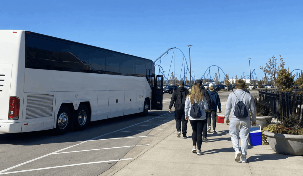columbus group returning to a charter bus after a cedar point day trip
